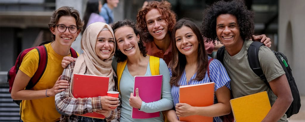 AdvancementStudents › Antioch University Students smiling with colorful notebooks